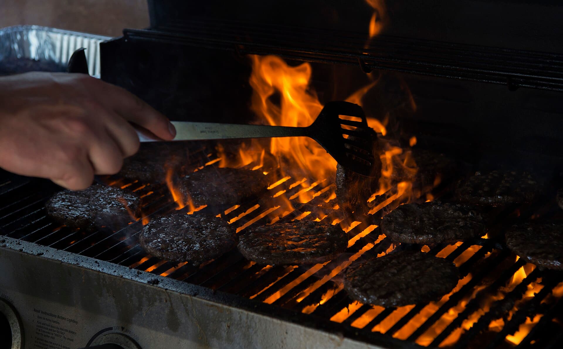 Hamburger patties cooking on a grill during a barbecue in Colorado