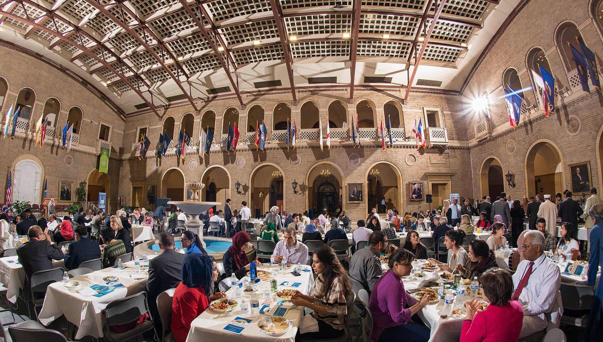 Guests moving along a buffet table during a USDA community iftar celebration