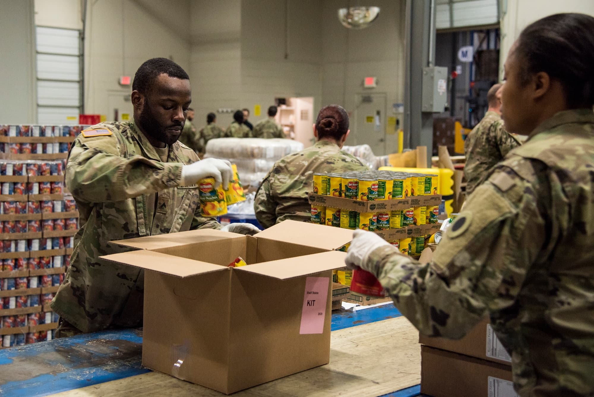 National Guard members packing canned goods for food bank distribution during COVID-19