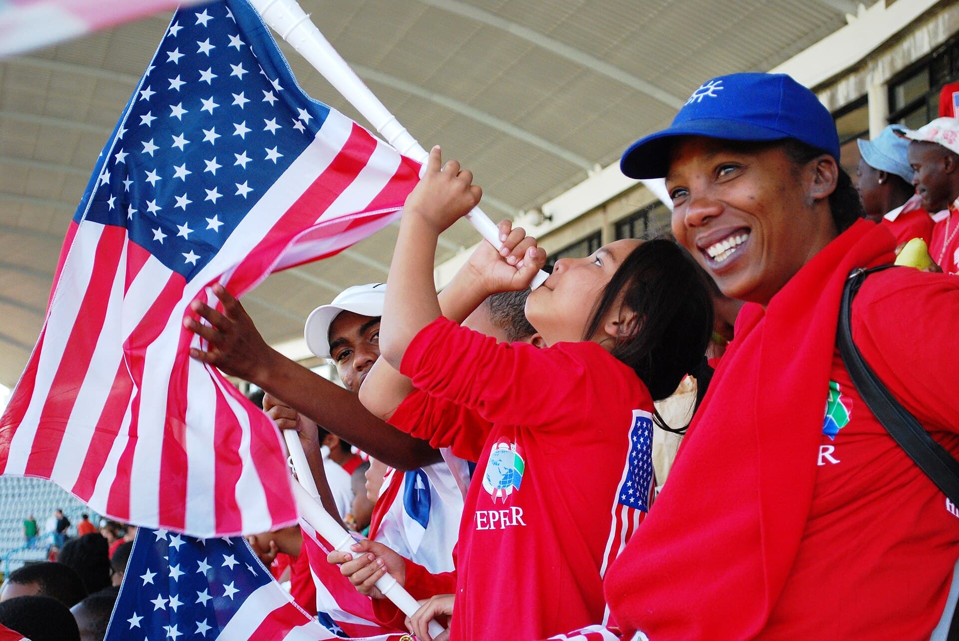 American soccer fans waving flags in a stadium